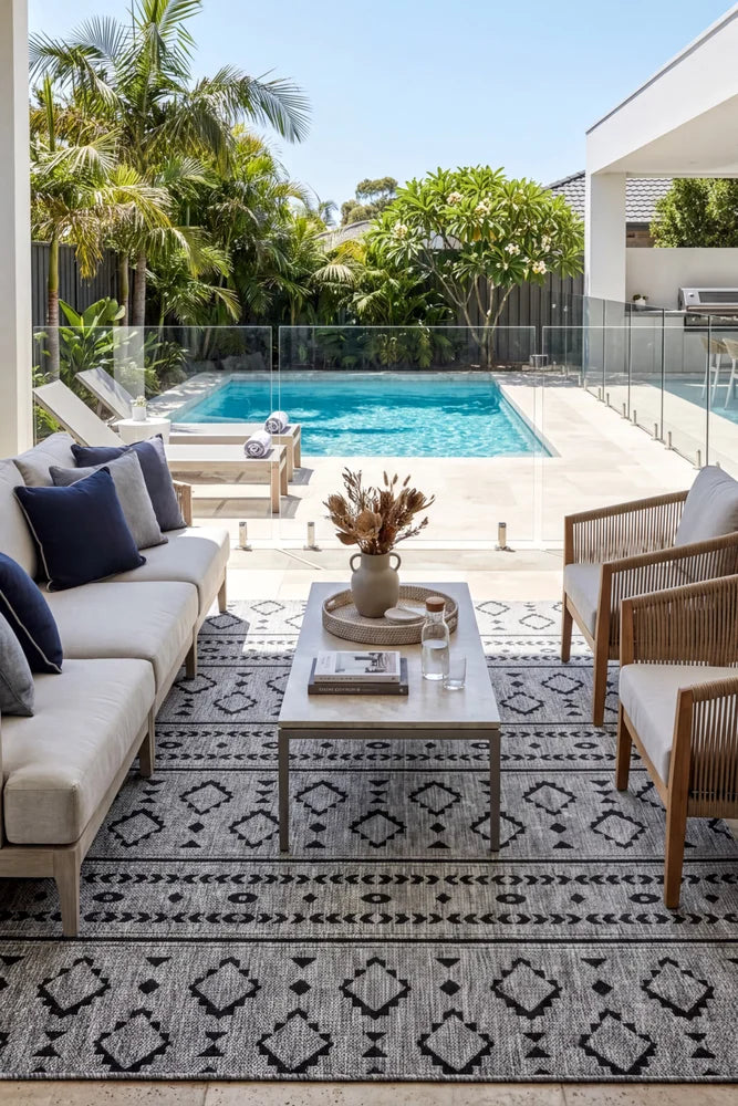 Alaska Indoor Outdoor 33 Dark Grey Rug — styled outdoor setting