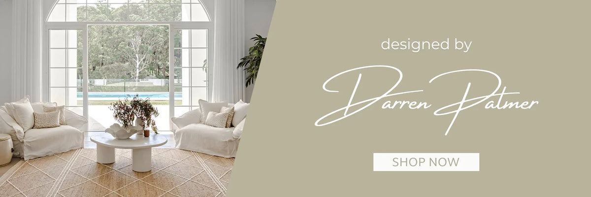 Designer Darren Palmer in a Hamptons-style living room featuring a natural jute rug