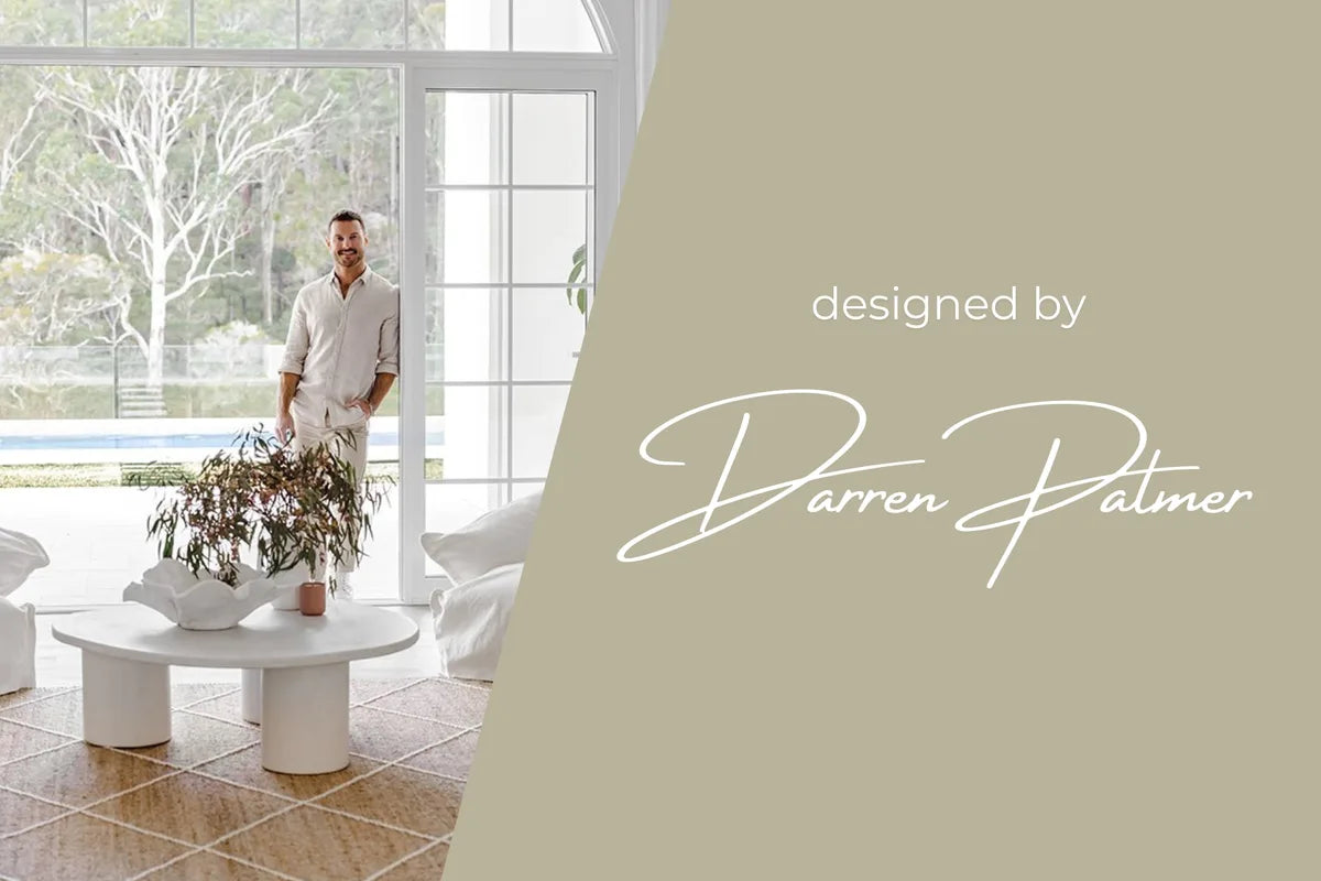Designer Darren Palmer in a Hamptons-style living room featuring a natural jute rug