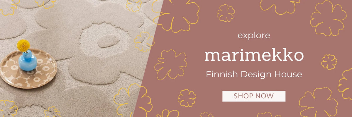 Cream Marimekko Unikko floral wool rug styled with a blue vase, from Finnish design house Marimekko