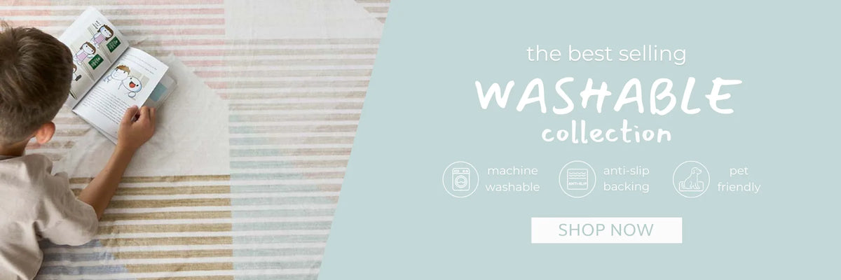 Young child reading on a striped washable rug from the machine-washable, anti-slip and pet-friendly collection