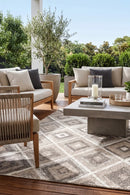 Alexandria Beige Indoor Outdoor Rug — styled outdoor setting