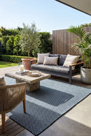 Bekal Indigo Blue Indoor Outdoor Rug — styled outdoor setting