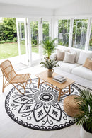 Benaras Black & White Reversible Round Outdoor Rug — styled indoor setting