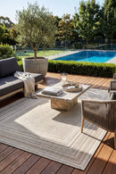 Colorado Lines Beige Outdoor Rug — styled outdoor setting