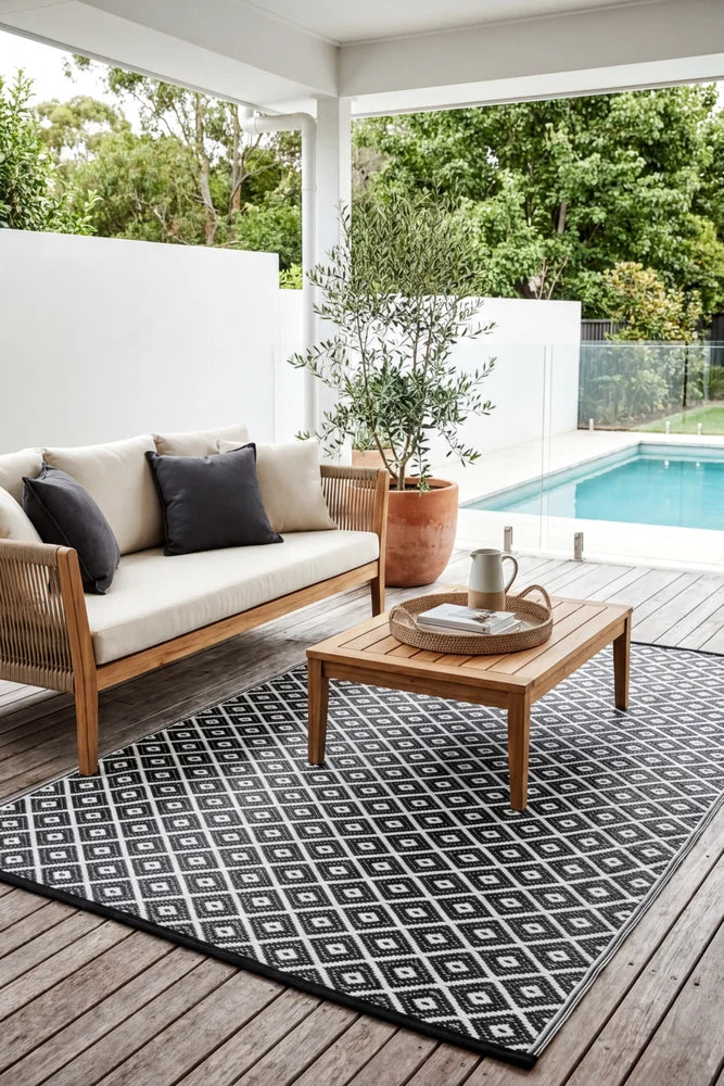 Kimberley Black Reversible Outdoor Rug — styled outdoor setting