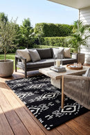 Surah Black Indoor Outdoor Rug — styled outdoor setting